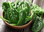 Spinach leaves in a wooden plate