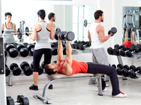Group of people in sport fitness gym weight training