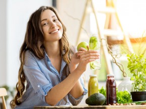 Woman with green healthy food and drinks at home